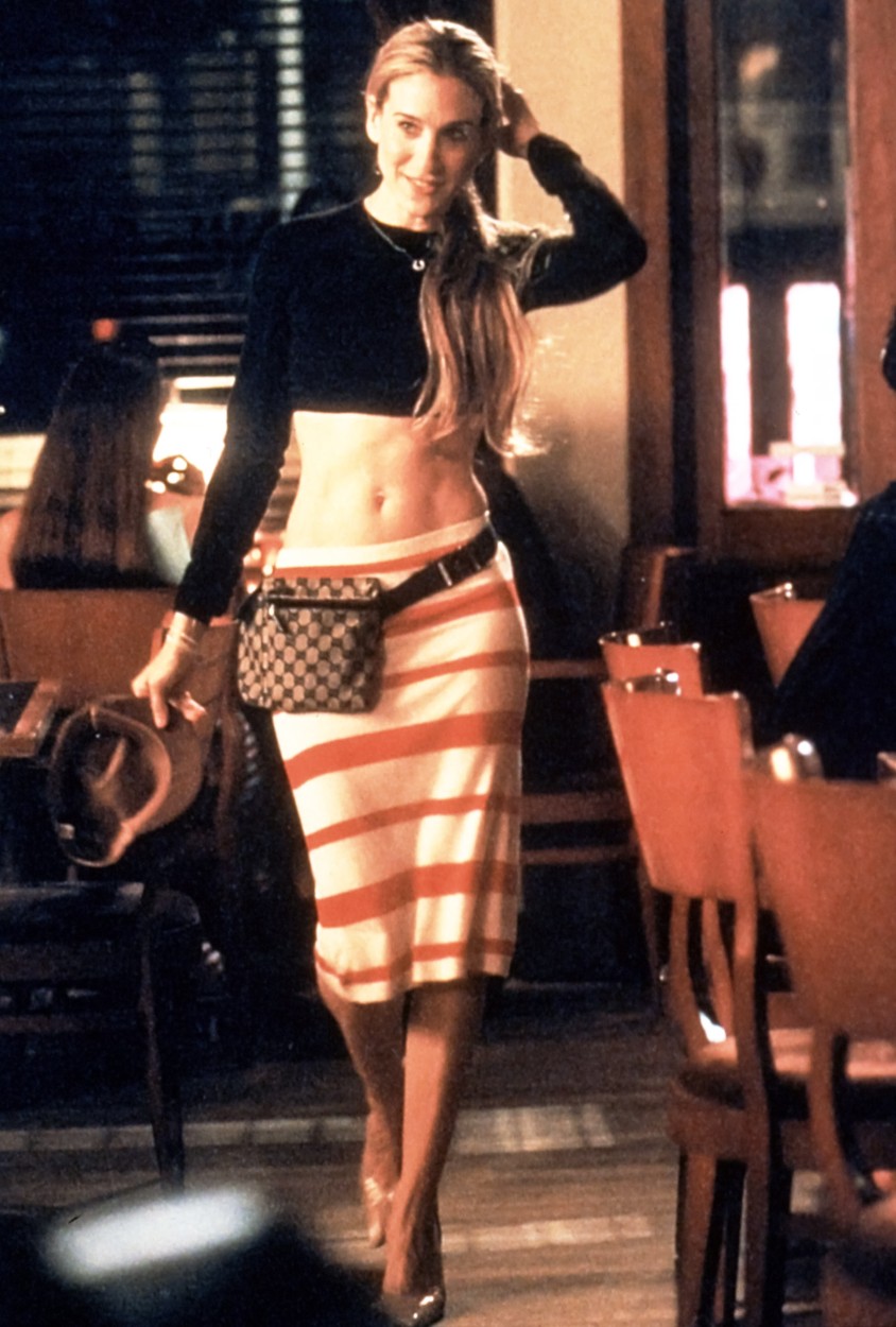 Sarah Jessica Parker îmbrăcată cu o rochie mulată, cro-top, borsetă și tocuri