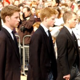 Prințul Harry, Prințul William și vărul lor, îmbrăcați în costume negre, la o înmormântare