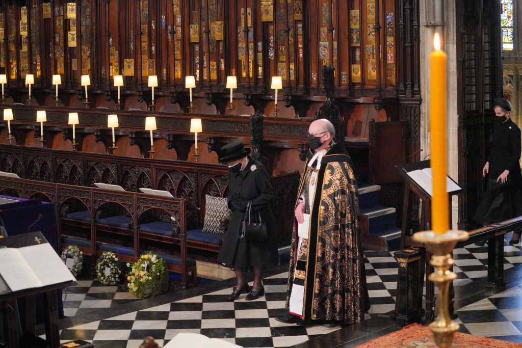 Regina Elisabeta, îmbrăcată în negru, cu capul plecat, la înmormântarea Prințului Philip