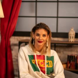 Ramona Olaru, îmbrăcată cu un hanorac Gucci și o pereche de blugi deschiși la culoare, stă pe un scaun în studioul CaTine.ro.