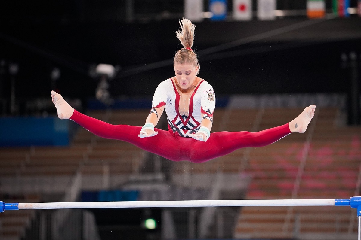 Elisabeth Seitz într-un costum roșu cu alb în timp ce execută o săritură cu picioarele în șăagat la Jocurile Olimpice de la Tokyo din 2020
