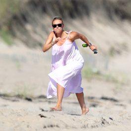 Scarlett Johansson pe plajă în The Hamptons, SUA. Actrița a optat pentru o rochie albă, largă, și o pereche de ochelari de culoare neagră