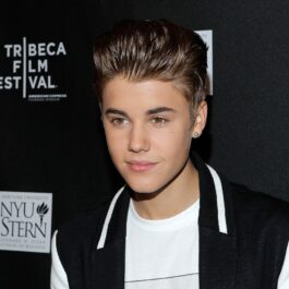 Portretul artistului Justin Bieber care poartă o bluză albă și o vestă neagră la Festivalul de Film de la Tribeca din 2012