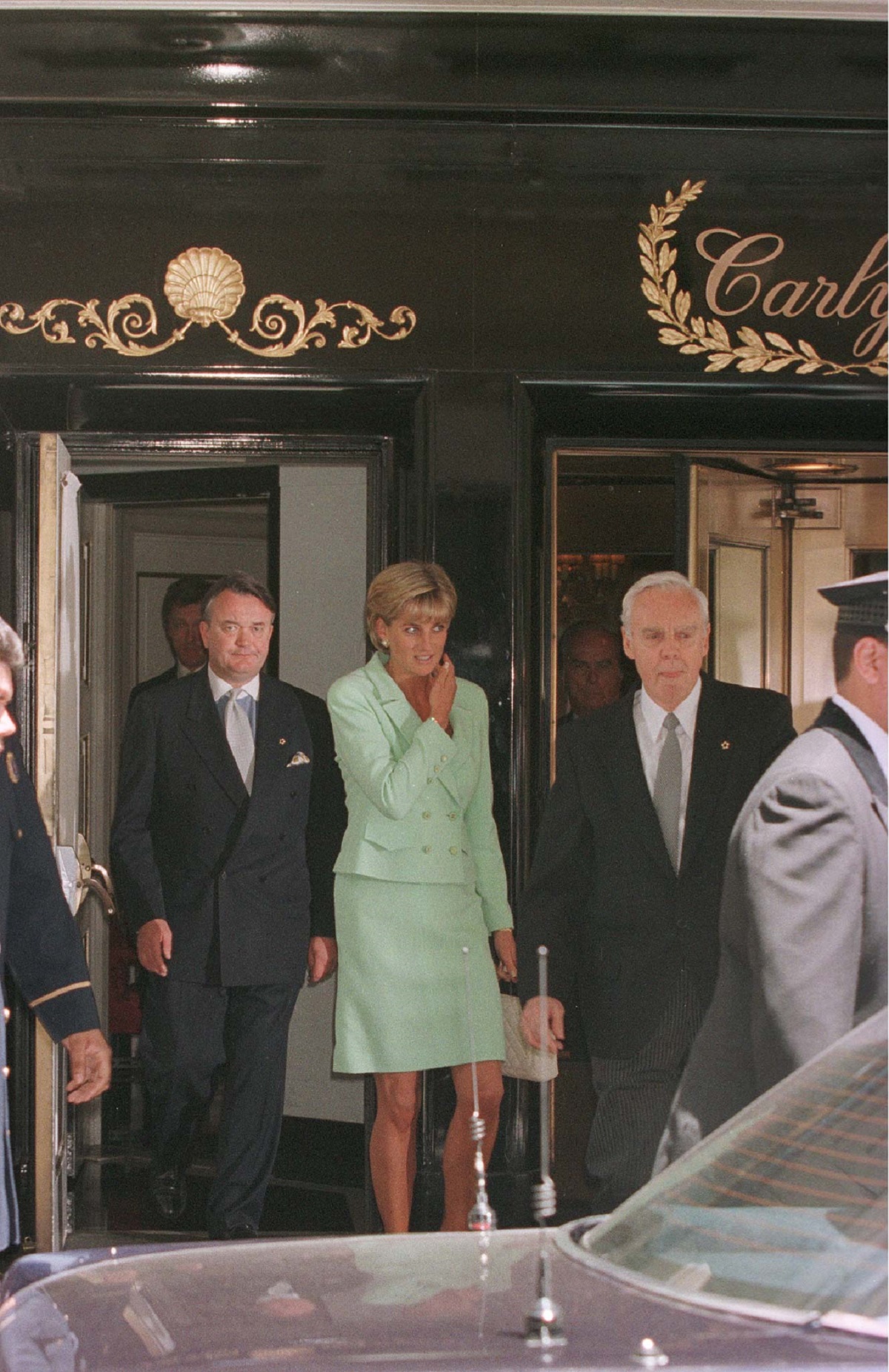 Prințesa Diana într-un costum verde în timp ce se află în fața unui hotel din New York