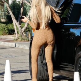Khloe Kardashian, fotografiată cu spatele, în timp ce coboară din mașină