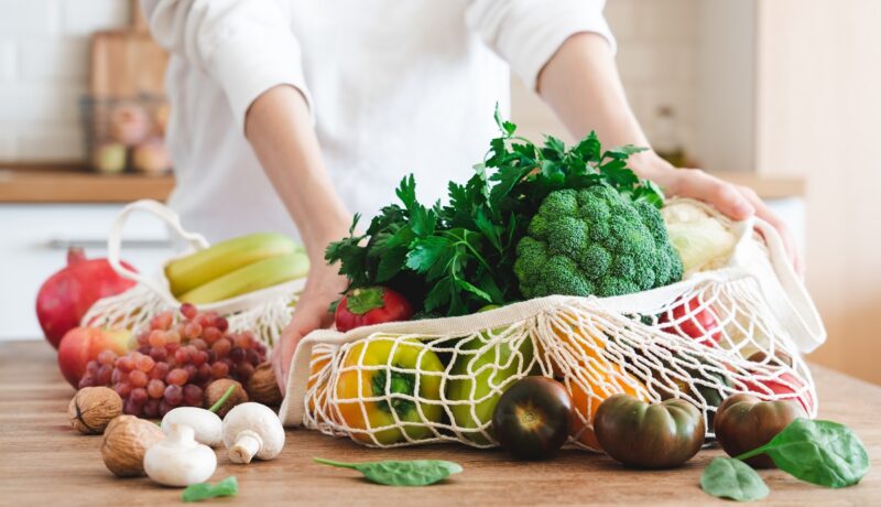 O masă pe care se află o pungă cu alimente pentru a demonstra cum poți avea o dietă sustenabilă