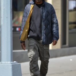 Chris Rock îmbrăcat într-un tricou negru și o jachetă albastră în timp ce se plimbă pe străzile din New York