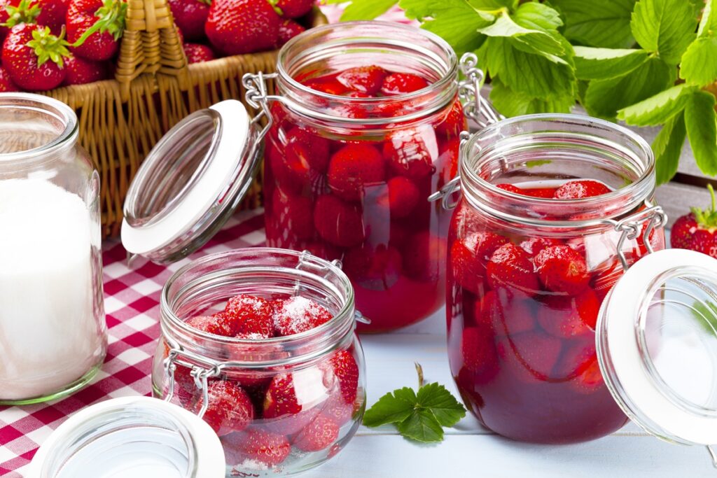 Three cans of strawberries made from compote