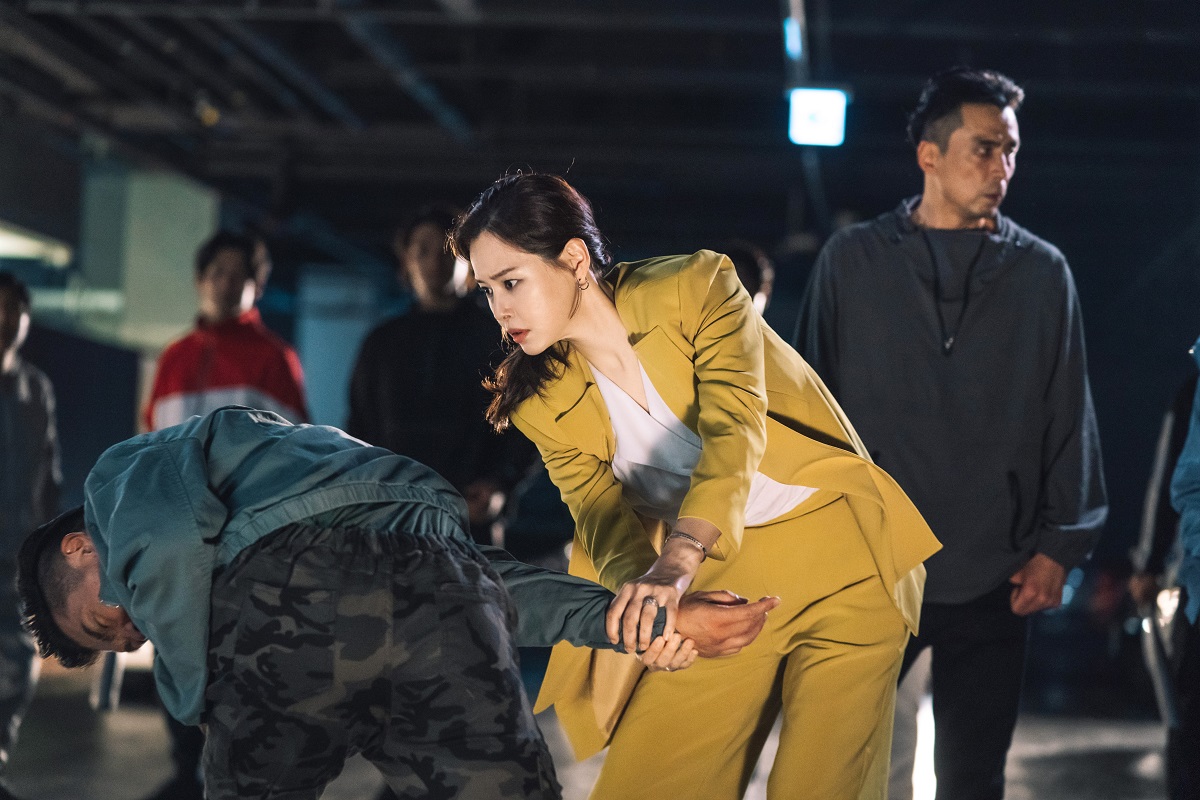 Actrița principală din seralul coreean One The Woman într-un costum galben în timp ce interpretează personajul Jo Yeon-Joo