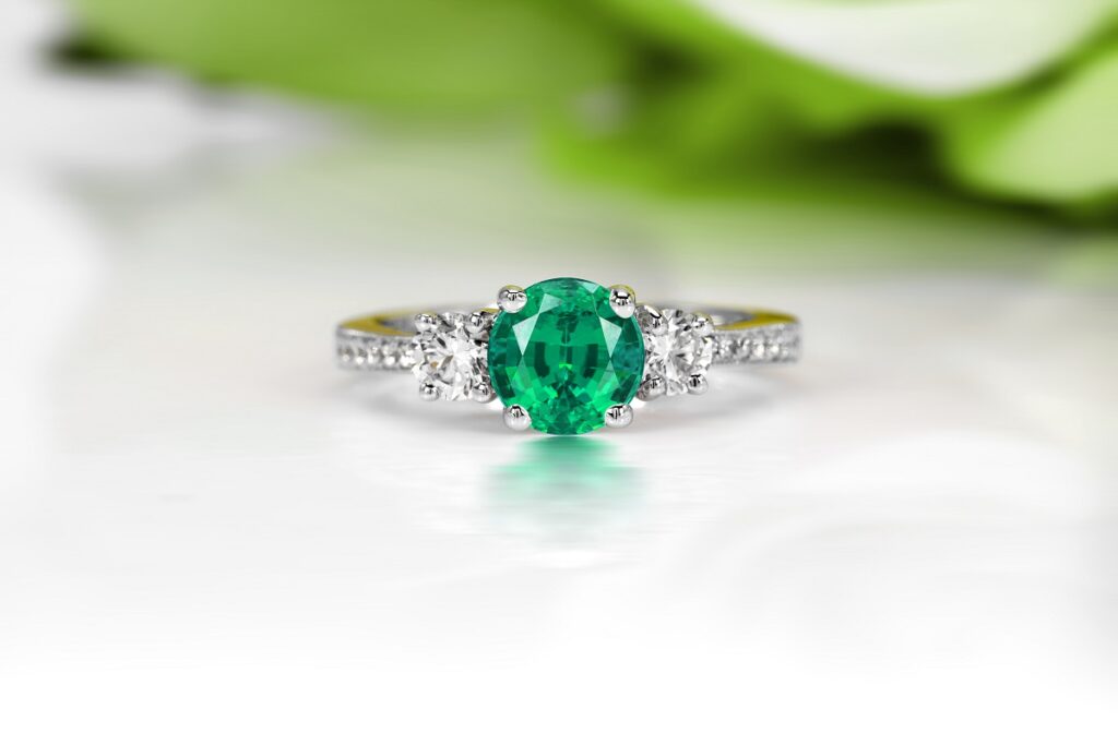 Un inel de logodnă care este decorat cu un smaralr
