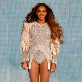 Beyonce, pe scenă, într-o rochie scurtă, argintie