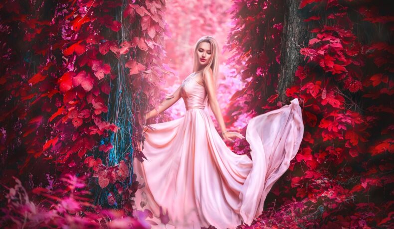 O femeie frumoasă într-o pădure roz în timp ce poartă o rochie roz pentru a ilustra una din cele trei zodii norocoase în ziua de 5 noiembrie 2022