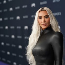 Kim Kardashian poartă o rochie neagră din latex, care îi vine pe corp, în cadrul unui eveniment din Los Angeles