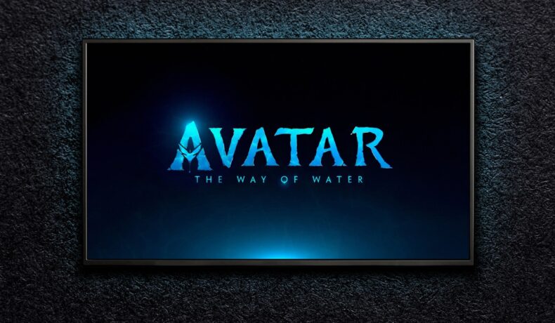 Un panou informativ aflat pe un fundal negru anunță numele filmului Avatar 2 scris cu albastru