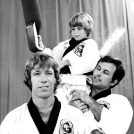Chuck Norris alături de doi dintre clienții săi de la clubul de karate