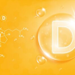 O fotografie care lustrează vitamina D pe un fundal orange