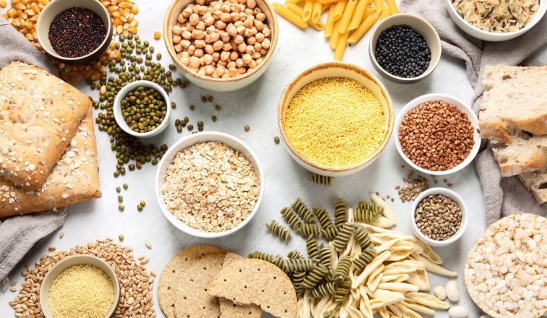 O masă plină cu cereale, semințe de chia și alte produse care conțin carbohidrați