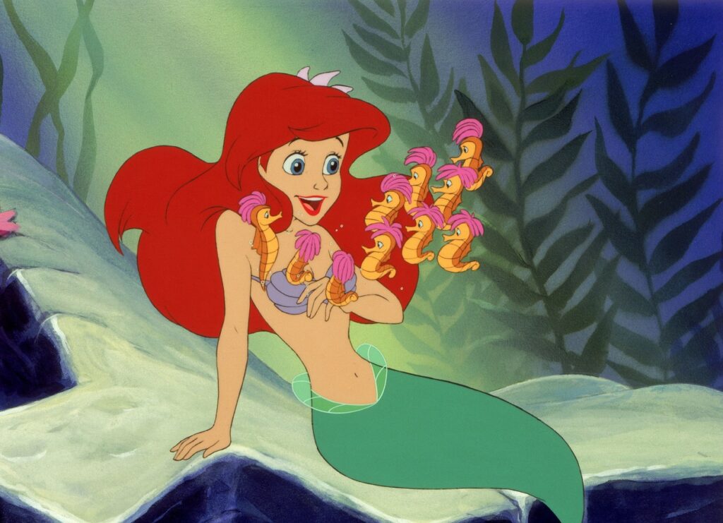 Ariel, în adâncuri, în timp ce se distrează cu peștii