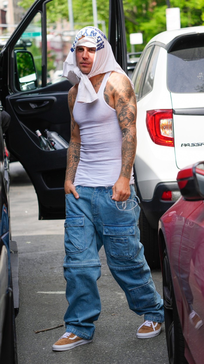 Justin Bieber, pe stradă, cu un tricou alb pe cap și o ținută casual