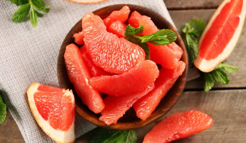 Un bol mare plin cu felii de grapefruit pentru a ilustra beneficiile acestuia pentru organism
