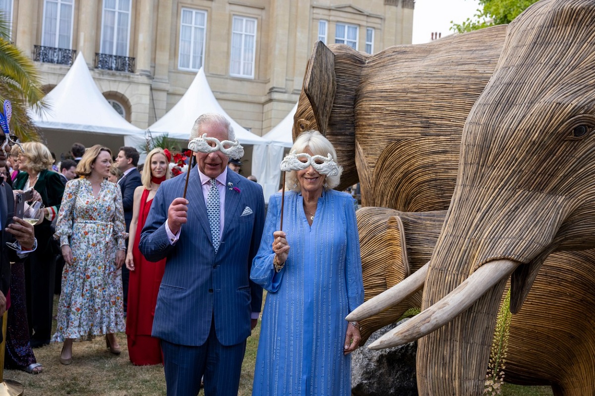 Regele Charles și Regina Camilla în timp ce poartă moști la Balul Animalelor