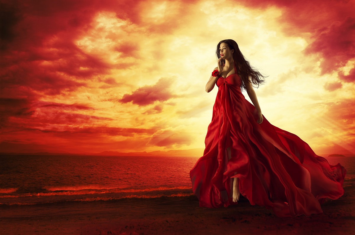 O femeie frumoasă cu o rochie roșie care reprezintă una dintre cele trei zodii impulsive