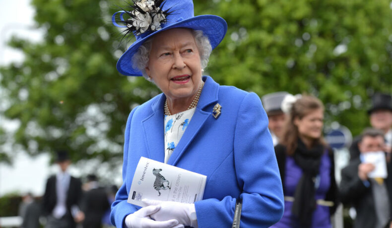 Regina Elisabeta, într-un costum de culoare albastru, asortat cu mănuși albe