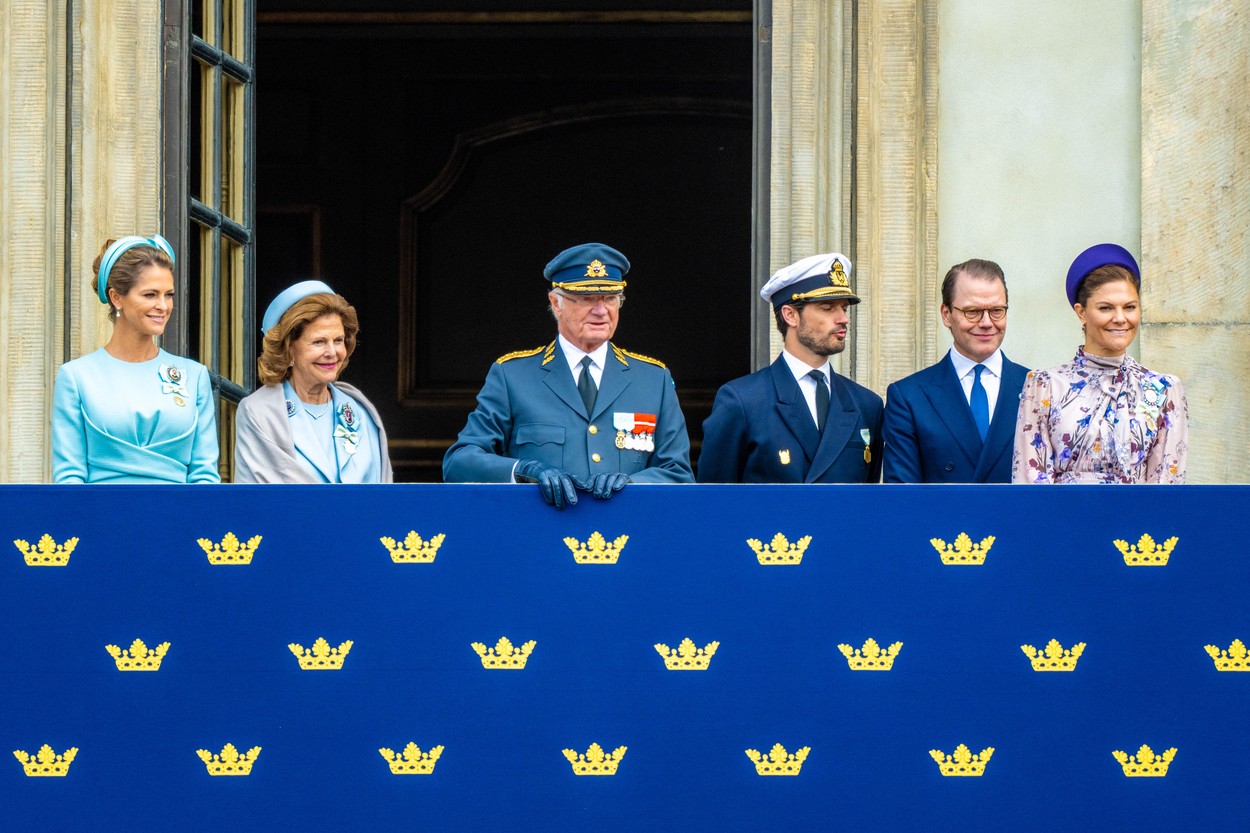 Regele Suediei, cu familia sa, la balconul palatului regal, îmbrăcați elegant
