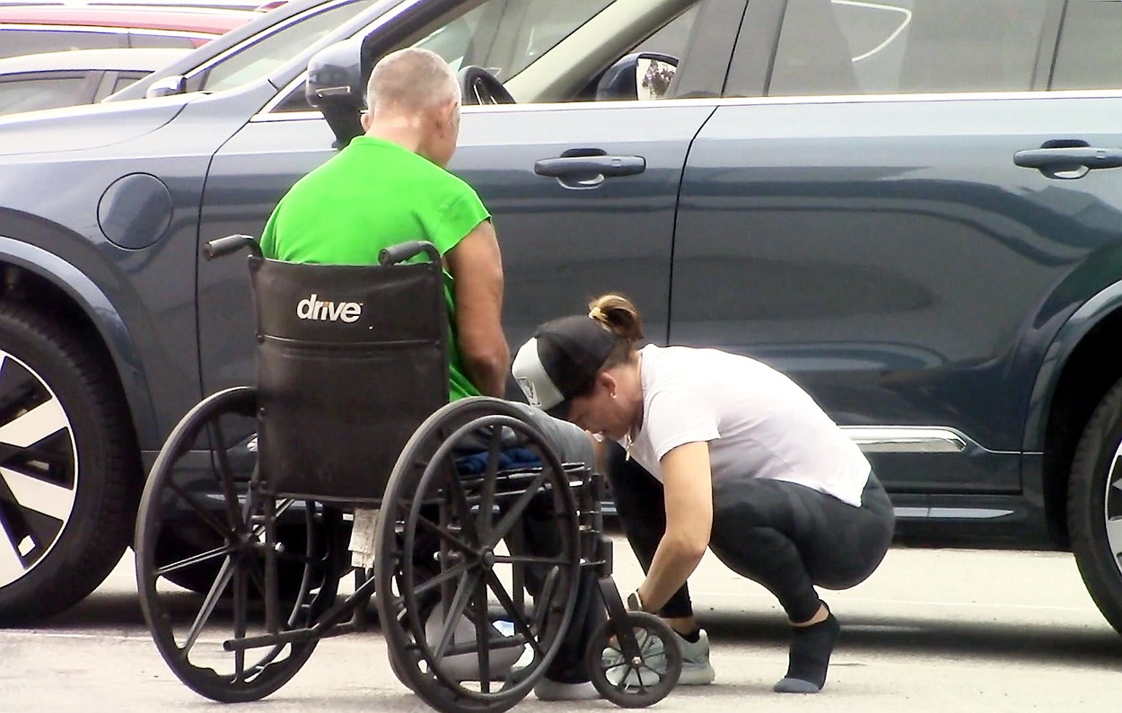 Jennifer Garner, lângă un bărbat în scaun cu rotile, fotografiată în timp ce încearcă să-l încalțe