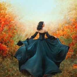 O femeie frumoasă care poartă o rochie neagră și aleargă într-o pădure aurie pentru a ilusytra una dintre cele trei zodii care se îndrăgostesc în luna noiembrie 2023