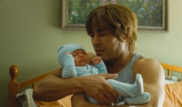 Zac Efron, imagini din filmul The Iron Claw, cu un bebeluș în brațe