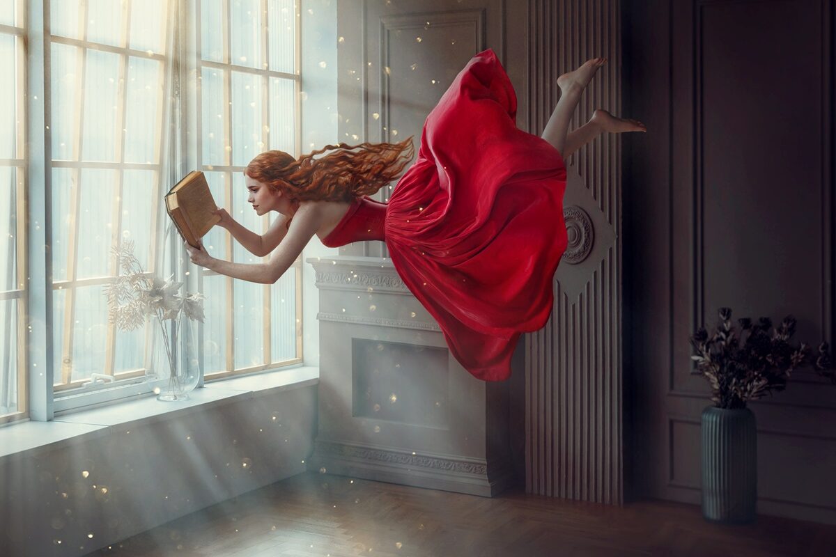 O femeie frumoasă care plutește și paortă o rochie roșie fiind una dintre zodiile catente la detalii