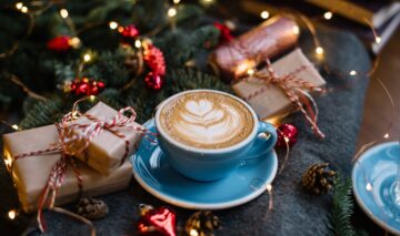 O ceașcă de cafea servită printre cadouri pentru dimineața de Crăciun