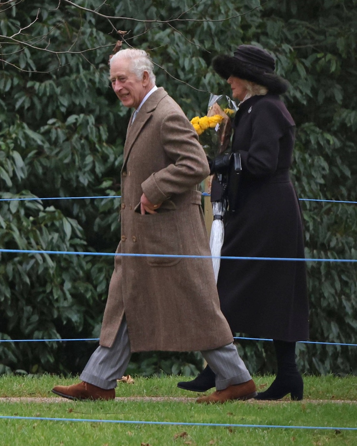 Regele Charles și Regina Camilla în timp ce vin de la slujba de Crăciun