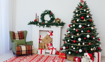Un brad de Crăciun pus lângă un șemineu și un fotoliu pentru a ilustra unde se punde bradul de Crăciun în casă