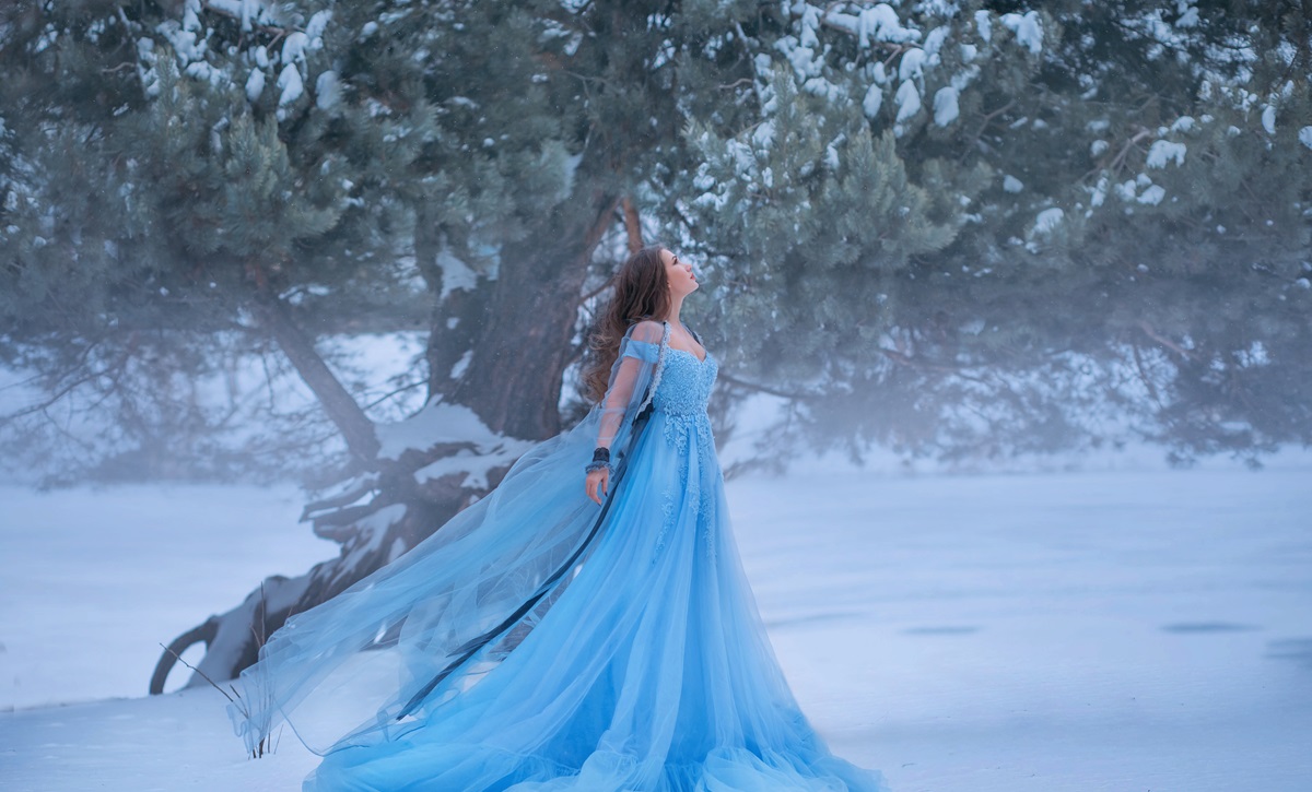 O femeie frumoasă care poartă o rochie albastră și ilustrează zodia nefericită a lunii decembrie 2023