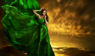 O femeie frumoasă care poartă o rochie verde și ilustrează una dintre zodiile care au de suferit din cauza temperamentului său