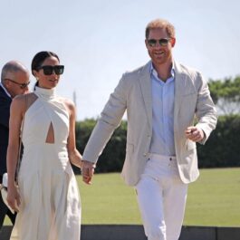 Meghan Markle într-o ținută luxoasă în timp ce se ține de mână cu Prințul Harry